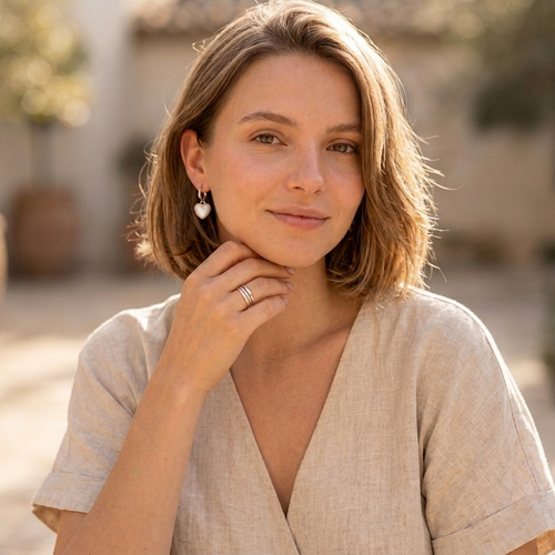 Model with silver heart huggies earrings 